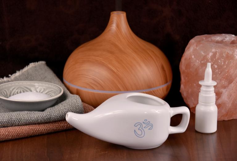 White neti pot in front of aromatherapy device.
